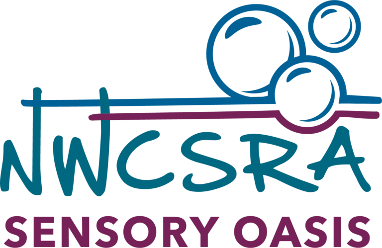This logo is for the Sensory Oasis Room. "NWCSRA" is in the middle in blue, with "Sensory Oasis" right below it in purple. There are three bubbles just above the blue letters, with blue on top and purple on the bottom. Instead of the colors touching to complete the bubbles, both colors diverge and stretch outward.