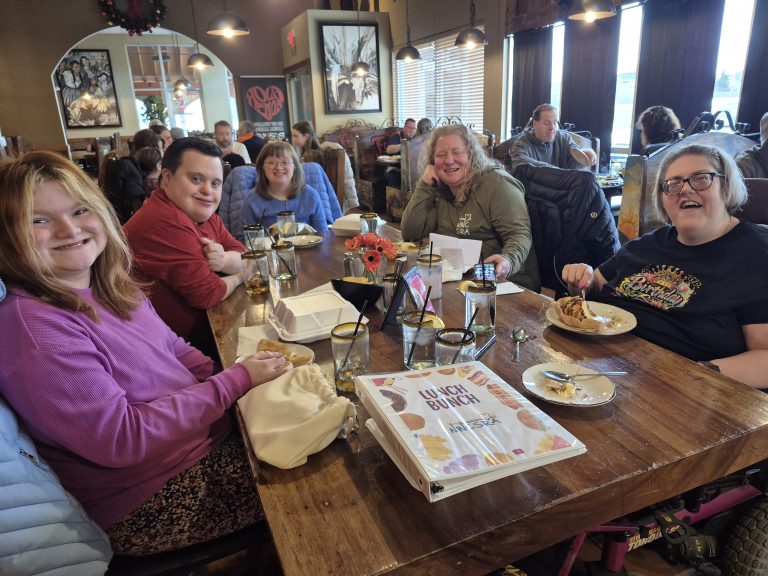 Staff member at Friday Foodies mexican restaurant with participants at table
